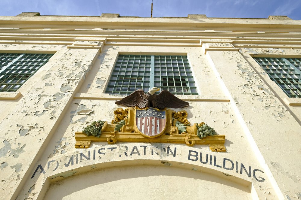 In this photo taken Tuesday, Nov. 12, 2019, the word "Free" is painted below an eagle figure that hangs on the entryway to the main cell house on Alcatraz Island in San Francisco. The words were added during the Native American occupation of the island. The week of Nov. 18, 2019, marks 50 years since the beginning of a months-long Native American occupation at Alcatraz Island in the San Francisco Bay. The demonstration by dozens of tribal members had lasting effects for tribes, raising awareness of life on and off reservations, galvanizing activists and spurring a shift in federal policy toward self-determination. (AP Photo/Eric Risberg)