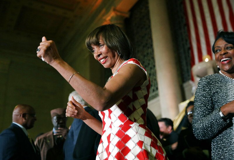 FILE - In this Dec. 6, 2016 file photo, Baltimore Mayor Catherine Pugh gives a thumbs-up to supporters after her inauguration ceremony inside the War Memorial Building in Baltimore. The disgraced former mayor of Baltimore was charged Wednesday, Nov. 20, 2019, with fraud and tax evasion involving sales of her self-published children's books.