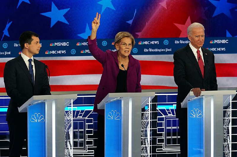 Elizabeth Warren speaks out Wednesday during the Democratic presidential debate in Atlanta. Warren and Pete Buttigieg (left) clashed over health care programs. Buttigieg’s rise in the polls made him a prime target for the other candidates. Former Vice President Joe Biden is shown at right.
