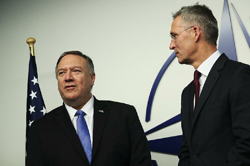 U.S. Secretary of State Mike Pompeo, left, is welcomed by NATO Secretary General Jens Stoltenberg after arriving for a NATO Foreign Ministers meeting at the NATO headquarters in Brussels, Wednesday, Nov. 20, 2019. 