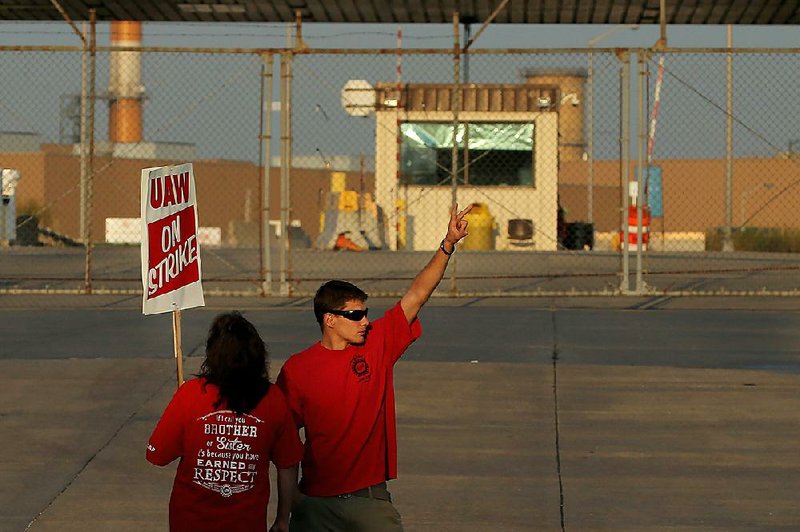 Production workers with the United Auto Workers union picket in September outside the General Motors truck assembly plant in Wentzville, Mo.