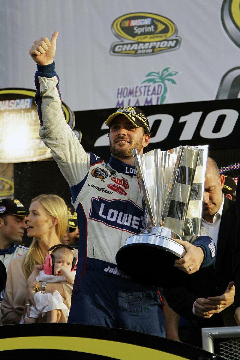 NASCAR driver Jimmie Johnson celebrates after winning his fifth Sprint Cup Series Championship on Nov. 21, 2010, in Homestead, Fla. Johnson is the latest NASCAR superstar to climb out of his car, with the seven-time champion announcing Wednesday that 2020 will be his final season of full-time racing. 