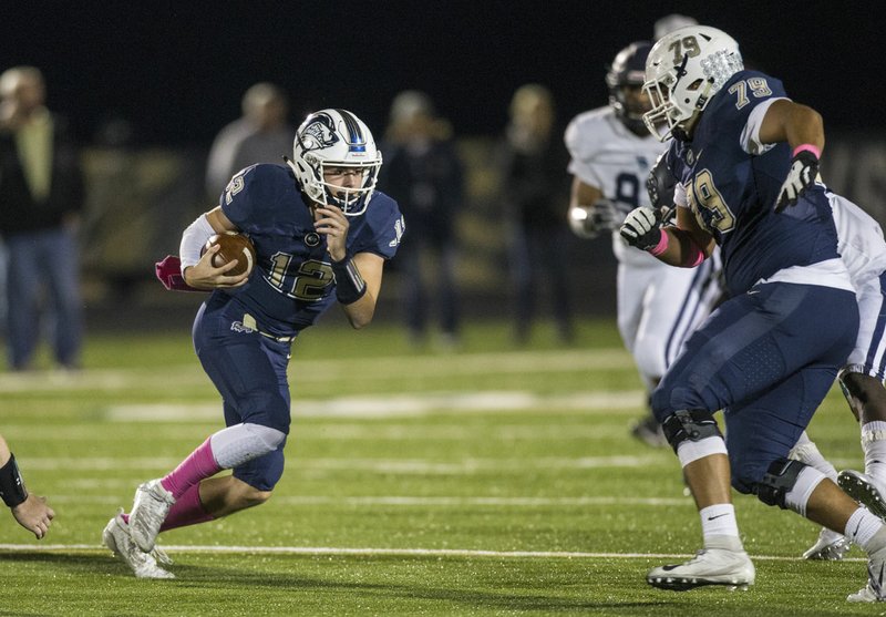 NWA Democrat-Gazette/BEN GOFF @NWABENGOFF Dalton McDonald, Bentonville West quarterback, runs the ball as Bentonville West Jaden Muskrat (79) block in the second quarter vs Springdale Har-Ber Friday, Oct. 18, 2019, at Wolverine Stadium in Centerton.