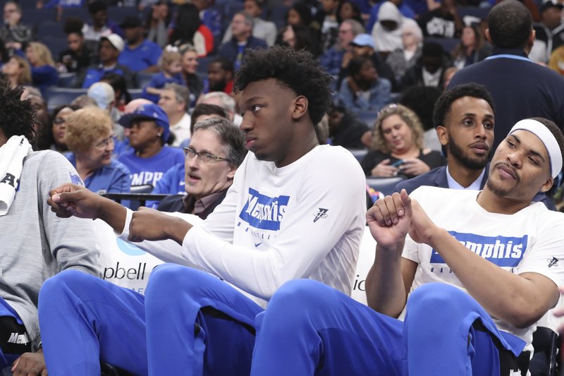 Memphis' James Wiseman, second from right, sits out the game along with Isaiah Stokes, right, in an NCAA college basketball game against Alcorn State Saturday, Nov. 16, 2019, in Memphis, Tenn. Malcolm Dandridge is first from right. (AP Photo/Karen Pulfer Focht)