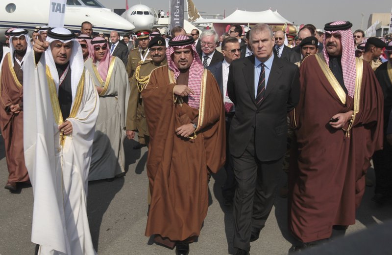 In this file photo dated Jan. 16, 2014, Bahraini Crown Prince Salman bin Hamad Al Khalifa, front row third right, tours the Bahrain International Airshow with British Prince Andrew, Duke of York, second right, and Bahraini Prince Abdullah bin Hamad Al Khalifa, right, in Sakhir, Bahrain. Britain's Prince Andrew said Wednesday that he is stepping back from public duties with the queen's permission, saying that recent disclosures regarding his association with the late convicted sex offender Jeffrey Epstein have become a "major distraction" to the royal family's work. - AP Photo/Hasan Jamali, FILE