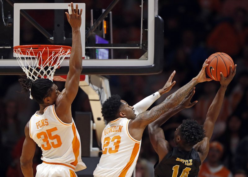 Alabama State forward Brandon Battle (14) has his shot blocked by Tennessee guard Jordan Bowden (23) during the first half of an NCAA college basketball game Wednesday, Nov. 20, 2019, in Knoxville, Tenn. Tennessee guard Yves Pons (35) is behind. (AP Photo/Wade Payne)