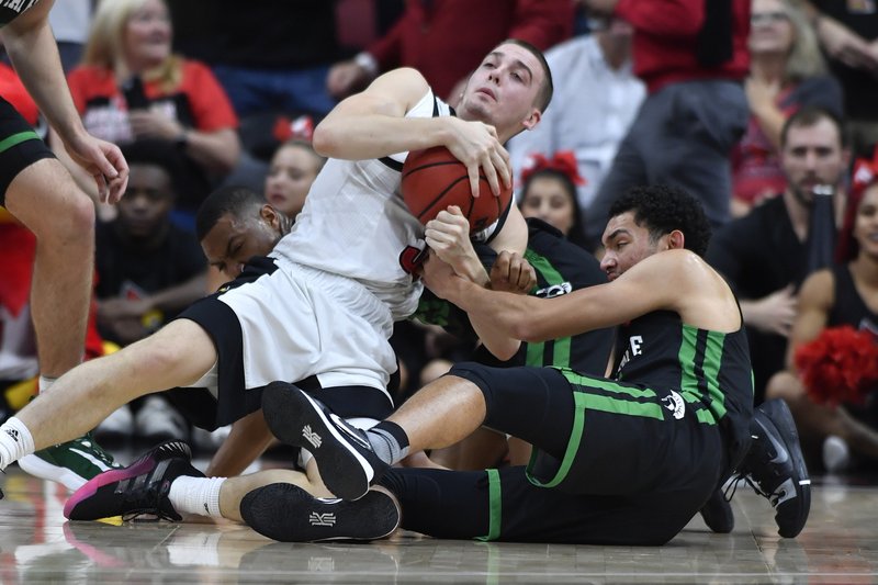 Louisville guard Ryan McMahon, left, battles South Carolina Upstate guard Josh Aldrich, right, for a loose ball during the first half of an NCAA college basketball game in Louisville, Ky., Wednesday, Nov. 20, 2019. (AP Photo/Timothy D. Easley)