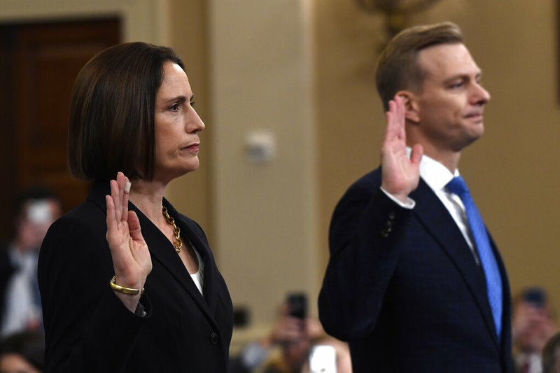 Former White House national security aide Fiona Hill, and David Holmes, a U.S. diplomat in Ukraine, are sworn in to testify before the House Intelligence Committee on Capitol Hill in Washington, Thursday, Nov. 21, 2019, during a public impeachment hearing of President Donald Trump's efforts to tie U.S. aid for Ukraine to investigations of his political opponents.(AP Photo/Susan Walsh)