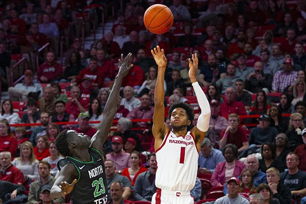 Arkansas' Isaiah Joe (1) shoots over the top of North Texas' Deng Geu during a game Tuesday, Nov. 12, 2019, in Fayetteville.