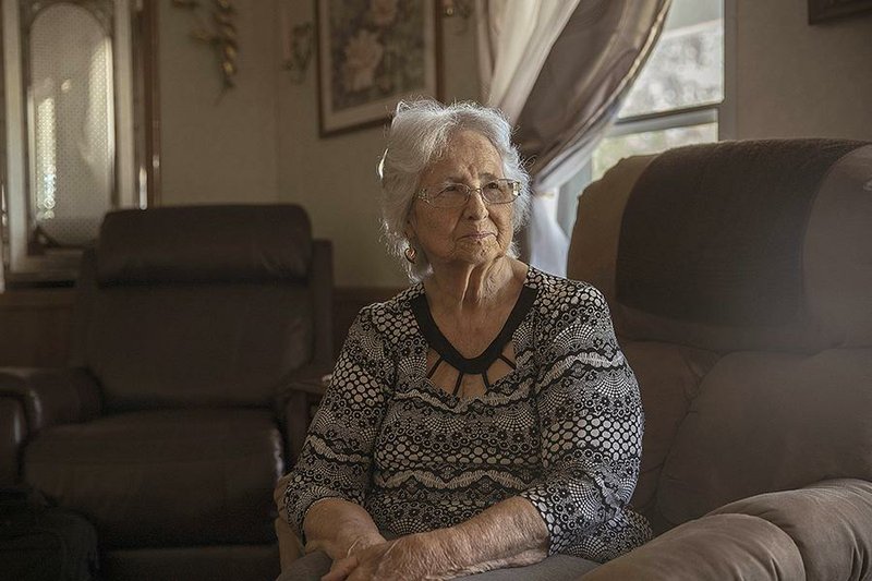 Earlene Peterson, whose daughter Nancy Mueller and granddaughter Sarah Powell were killed along with William Mueller by Chevie Kehoe and Daniel Lewis Lee 23 years ago, sits in her home in Hector in October. Peterson requested clemency for Lee, saying “he should have to live through this like I did.” 