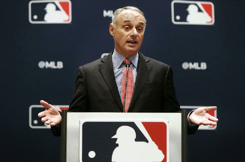 Major League Baseball Commissioner Rob Manfred speaks to the media at the owners meeting Thursday in Arlington, Texas. Manfred said MLB will “investigate the Astros situation as thoroughly as humanly possible.” 
