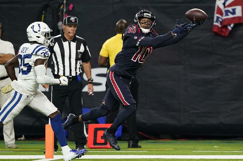 Houston Texans wide receiver DeAndre Hopkins makes a touchdown catch past Indianapolis Colts cornerback Pierre Desir during the second half Thursday in Houston. Hopkins had two touchdown receptions in Houston’s 20-17 victory. 