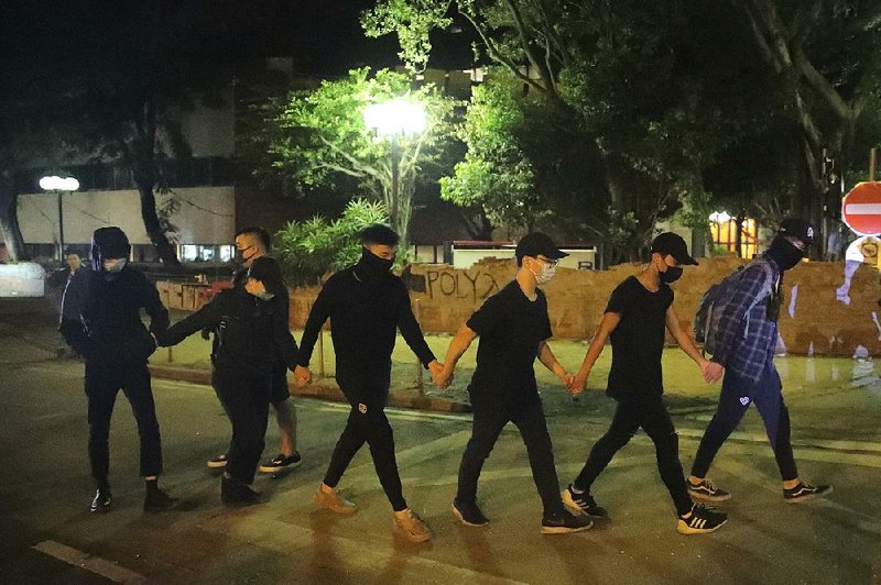 Protesters surrender to police Thursday near the Hong Kong Polytechnic University campus. 