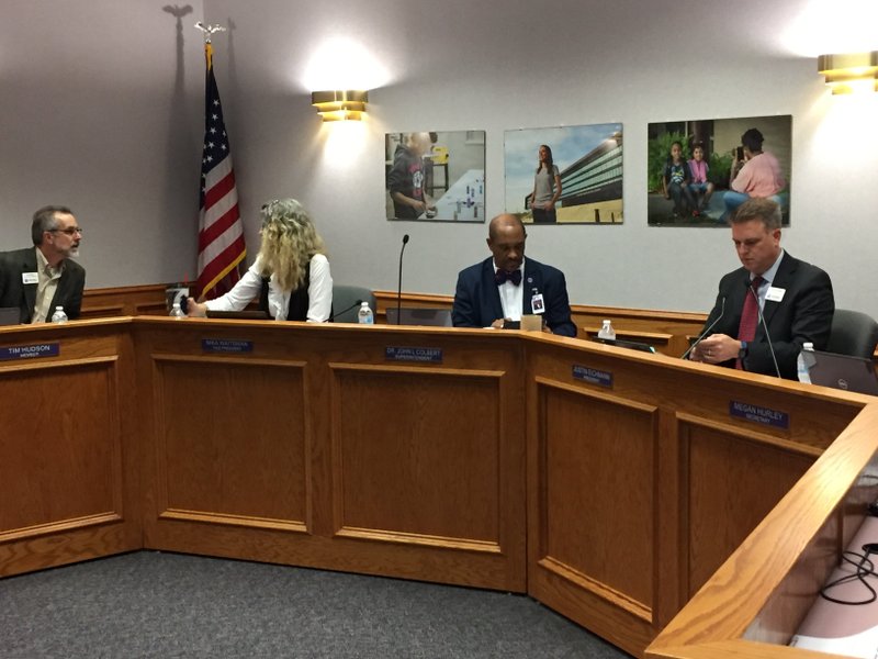 NWA Democrat-Gazette/DAVE PEROZEK John L Colbert (second from right), superintendent of the Fayetteville School District, prepares for Thursday's School Board meeting along with board members (from left) Tim Hudson, Nika Waitsman and Justin Eichmann.