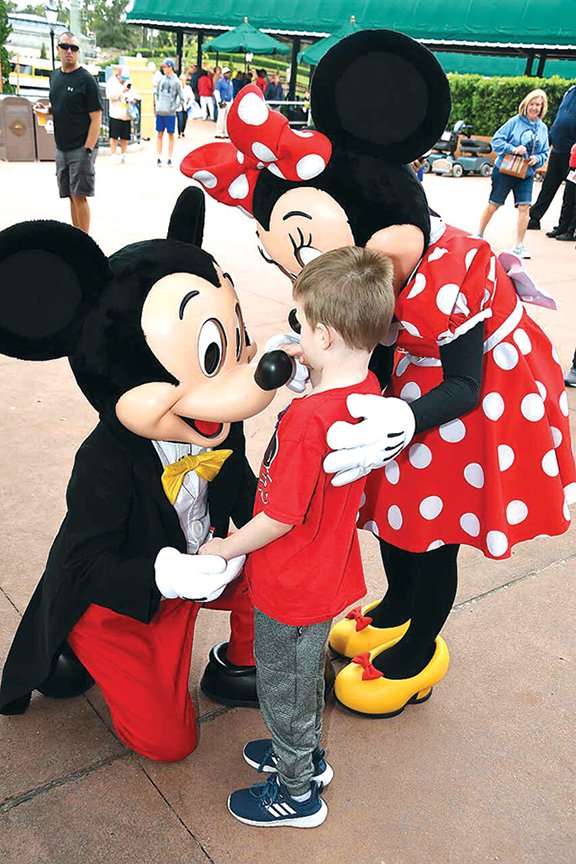 Jackson Barnes, 6, of Cabot, feels Mickey’s nose during a Make-A-Wish Foundation trip to Disney World and Sea World in Orlando, Fla., earlier this month. Jackson is losing his eyesight because of Batten disease, a fatal genetic disorder of the nervous system.