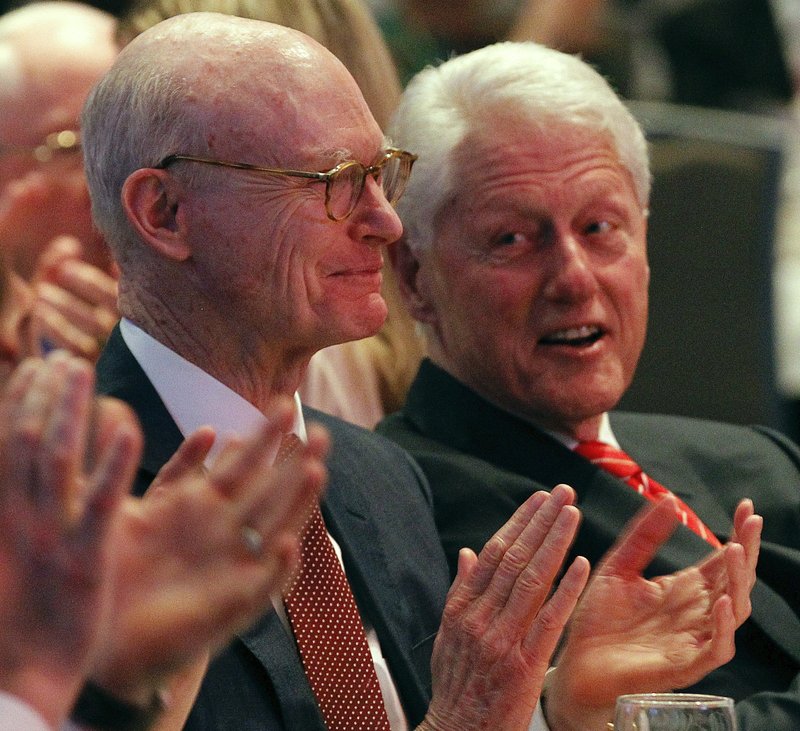 Walter E. Hussman Jr. (left), chairman of the parent company of the Arkansas Democrat-Gazette, laughs Thursday with former President Bill Clinton during the 200th anniversary celebration of the first issue of the Gazette.