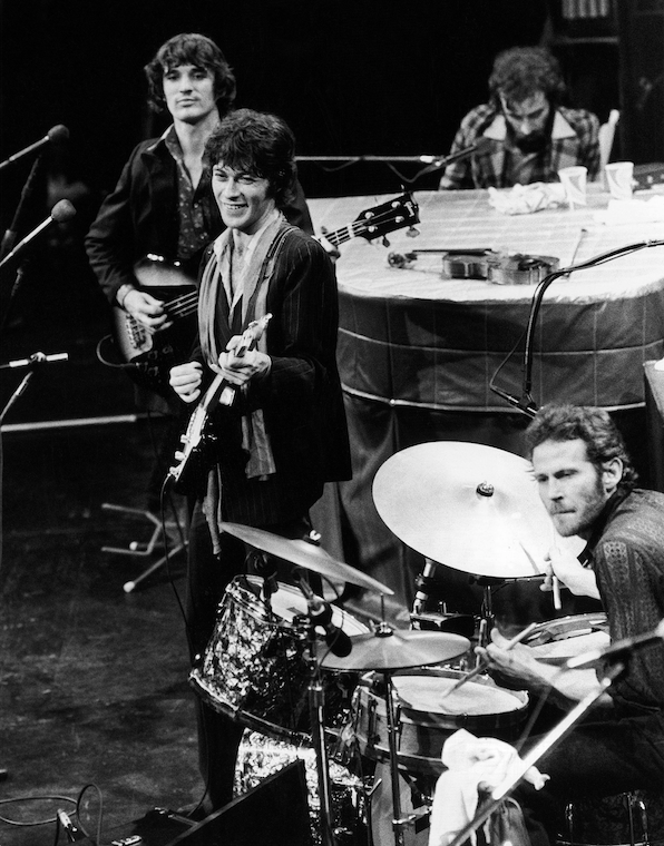 The Band (counterclockwise from top right), Richard Manuel on piano, Levon Helm on drums, lead guitarist Robbie Robertson and bass guitarist Rick Danko, take the stage for their final live performance before a crowd at Winterland Auditorium in San Francisco on Nov. 27, 1976. (AP)