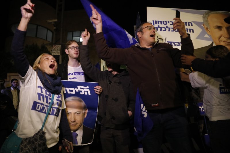 Supporters of Israeli Prime Minister Benjamin Netanyahu gather outside his residence in Jerusalem, Thursday, Nov. 21, 2019. Israel's attorney general charged Netanyahu with fraud, breach of trust and accepting bribes in three different scandals. It is the first time a sitting Israeli prime minister has been charged with a crime. (AP Photo/Ariel Schalit)
