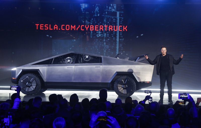 Tesla CEO Elon Musk introduces the Cybertruck on Thursday at Tesla's design studio in Hawthorne, Calif. The much-hyped unveil of Tesla's electric pickup truck went off script Thursday night when supposedly unbreakable window glass shattered twice when hit with a large metal ball. The failed stunt, which ranks high on the list of embarrassing auto industry rollouts, came just after Musk bragged about the strength of "Tesla Armor Glass" on the wedge-shaped Cybertruck. - AP Photo/Ringo H.W. Chiu