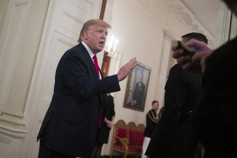 President Donald Trump talks with reporters during the NCAA Collegiate National Champions Day at the White House, Friday, Nov. 22, 2019, in Washington. (AP Photo/ Evan Vucci)