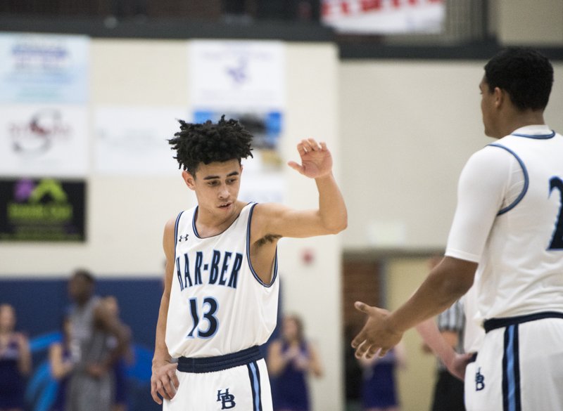 NWA Democrat-Gazette/CHARLIE KAIJO Springdale Har-Ber High School Nick Buchanan (13) fives teammate Zach Peck (22) during a basketball game, Friday, February 16, 2018 at Springdale Har-Ber in Springdale.