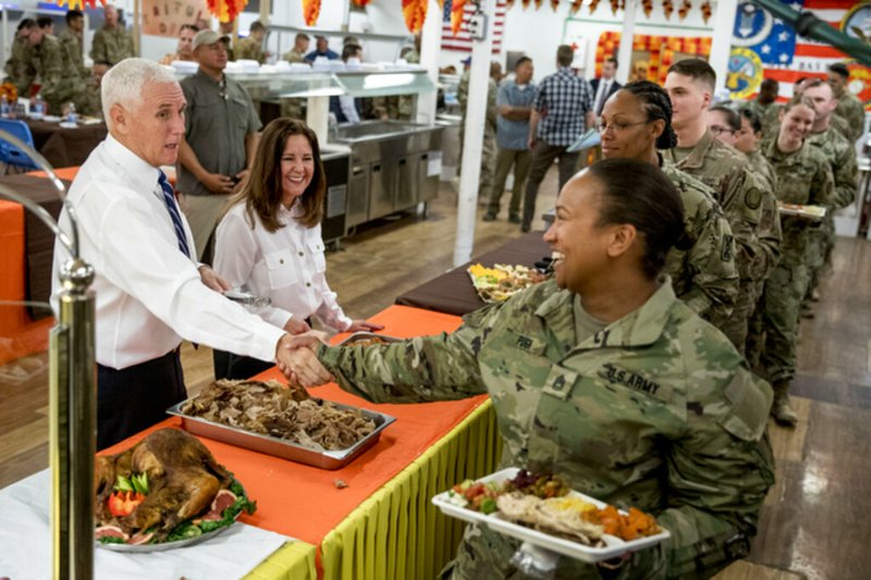 Vice President Mike Pence and his wife Karen Pence, second from left, serve turkey to troops at Al Asad Air Base, Iraq, Saturday, Nov. 23, 2019. The visit is Pence’s first to Iraq and comes nearly one year since President Donald Trump’s surprise visit to the country.