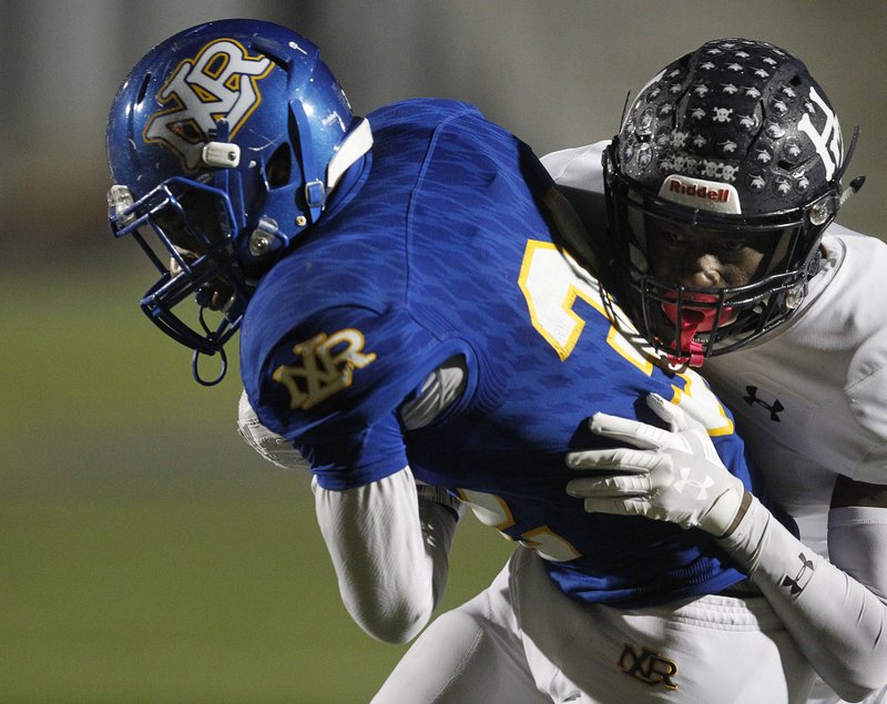 Arkansas Democrat-Gazette/THOMAS METTHE -- 11/22/2019 --
Springdale Har-Ber cornerback Jujuan Boyd (1) tackles North Little Rock running back Brandon Thomas (22) during the third quarter of North Little Rock's 49-21 win on Friday, Nov. 22, 2019, in North Little Rock.