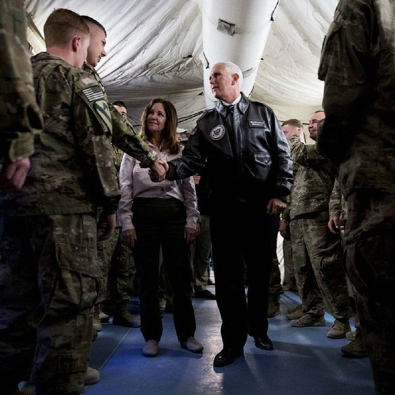 Vice President Mike Pence and his wife, Karen, greet U.S. troops Saturday at the airport in Irbil in Iraq’s semiautonomous Kurdish region. Pence delivered Thanksgiving dinner to the troops and met with Iraqi Kurdistan President Nechirvan Barzani. More photos at arkansasonline.com/1124pence/ 
