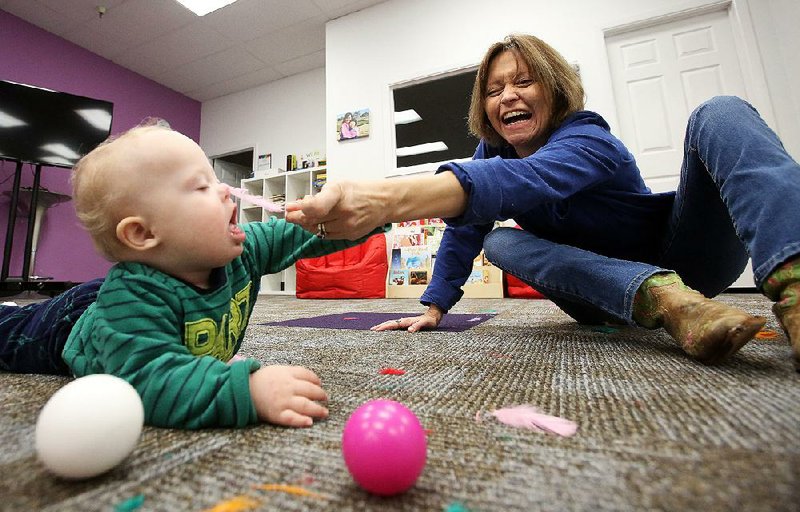 Lena Pearce plays Saturday with her 11-month-old son, Charlie, Saturday at Gigi’s Playhouse Down Syndrome Achievement Center in Little Rock. More photos at www.arkansasonline.com/1123gigis/ 