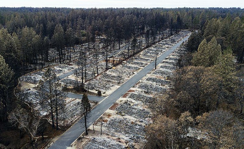 This Dec. 3, 2018, photo shows the remnants of homes in the Ridgewood Mobile Home Park retirement community in Paradise, Calif., after the Camp Fire wildfire devastated the area. 