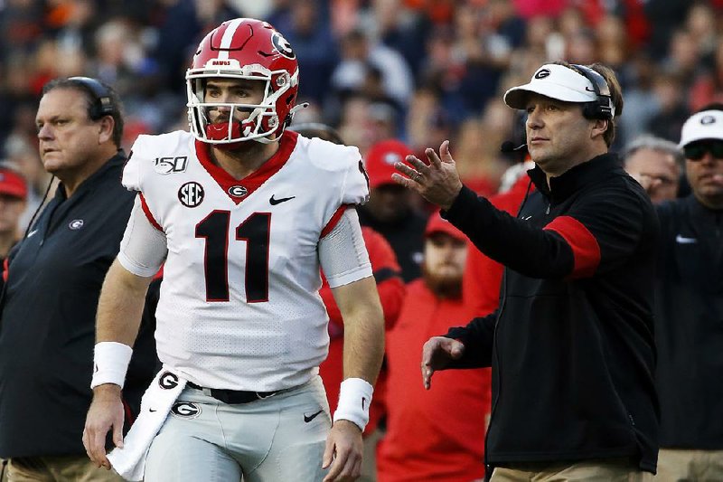 Coach Kirby Smart (right) and the No. 4 Georgia Bulldogs head into today’s game against Texas A&M looking for more ways to be explosive on offense after being held to 251 total yards against Auburn last week.  