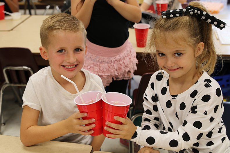 Lake Hamilton Primary School first-graders recently celebrated the 50th day of school by dressing in 1950s styles and drinking root beer floats, including Braxton Gilmore, left, and Tys-lee Gray. - Submitted photo story.lead_photo.caption