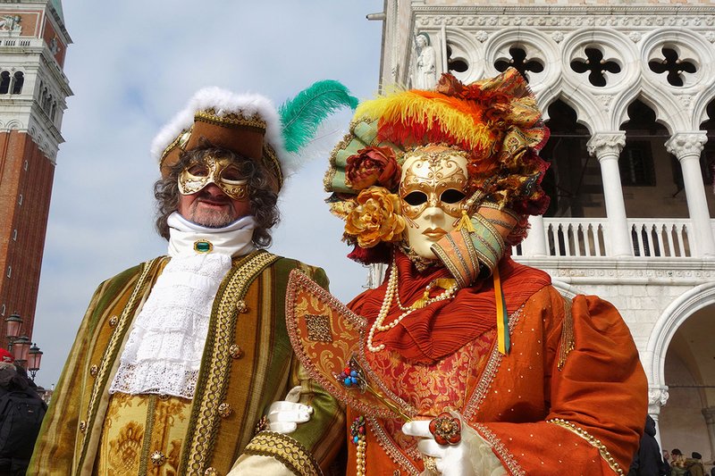 Revelers in ornate, outrageous costumes and colorful masks descend upon Venice during Carnival. (Photo by Simon Griffith via Rick Steves' Europe)