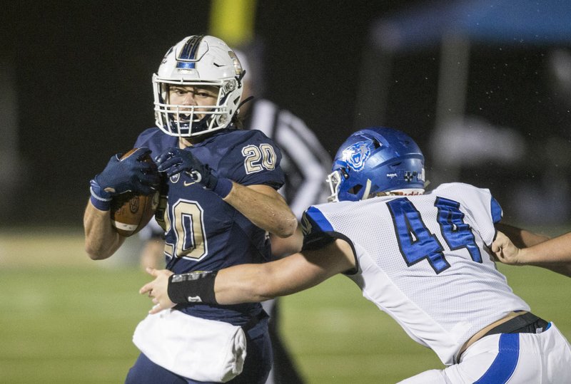 NWA Democrat-Gazette/BEN GOFF @NWABENGOFF Nick Whitlatch, Bentonville West running back, breaks the tackle of Reed Hughes, Conway defender, in the first quarter Friday, Nov. 22, 2019, at Wolverine Stadium in Centerton.