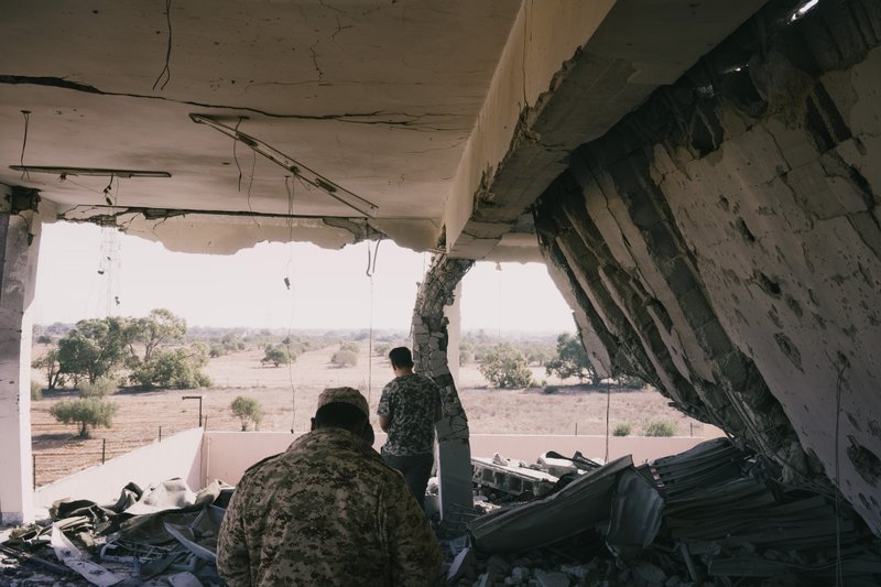 Two members of a militia backed by the Libyan government inspect damage in a building that was the center of military coordination during the offensive to liberate Sirte from Islamic State militants in 2016. MUST CREDIT: Photo for The Washington Post by Lorenzo Tugnoli