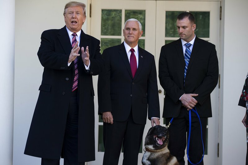 Vice President Mike Pence listens as President Donald Trump talks with reporters during a visit with Conan, the U.S. Army dog that participated in the raid that killed ISIS leader Abu Bakr al-Baghdadi, in the Rose Garden of the White House, Monday, Nov. 25, 2019, in Washington. (AP Photo/ Evan Vucci)