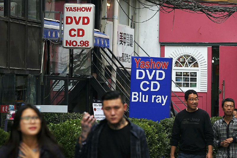 Theft of intellectual property by Chinese entities, such as this Beijing shop selling pirated movies and music, costs American companies up to $600 billion a year, according to the U.S. Stocks on Wall Street reached record highs Monday on the news that China was moving to address the issue. 