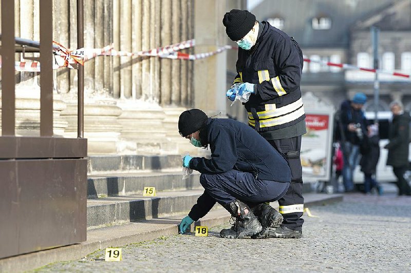 Police officers work behind caution tape near the Green Vault in Dresden, Germany, on Monday after three sets of 18th-century jewelry were reported stolen. 
