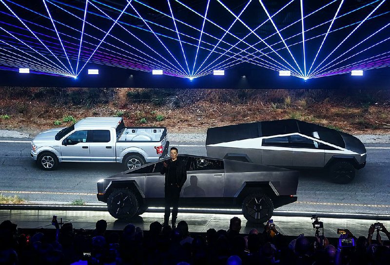 Tesla Chief Executive Officer Elon Musk introduces the Cybertruck last week in Hawthorne, Calif., as a video shows a tug of war between the pickup and a Ford F-150. 