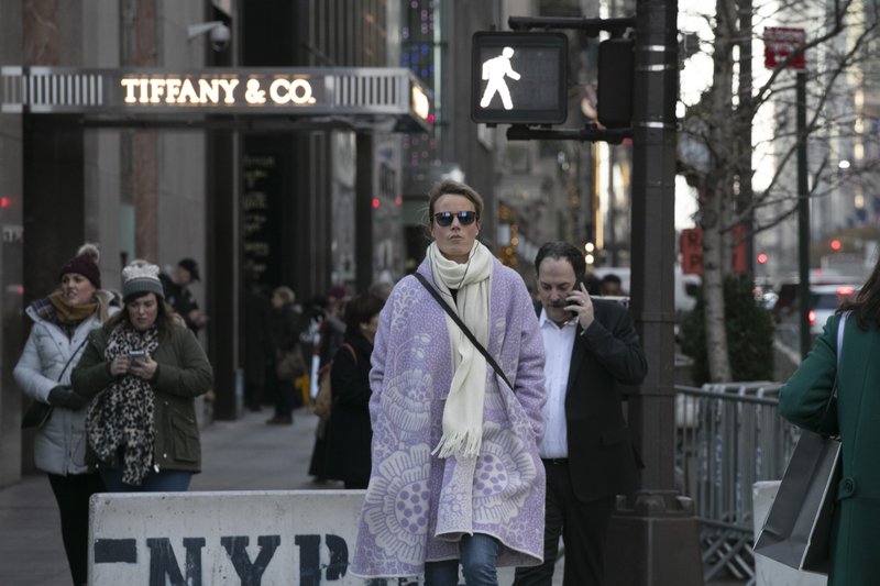 People walk by Tiffany's flagship store, Monday, Nov. 25, 2019 in New York. French luxury group LVMH has agreed to buy iconic New York jeweler Tiffany &amp; Co. for $16.2 billion, adding a famed star to its portfolio that already boasts Louis Vuitton, Christian Dior and Bulgari. (AP Photo/Mark Lennihan)
