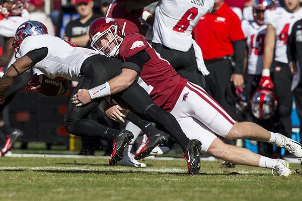 Arkansas linebacker Hayden Henry tackles Western Kentucky running back Gaej Walker during a game Saturday, Nov. 9, 2019, in Fayetteville. 