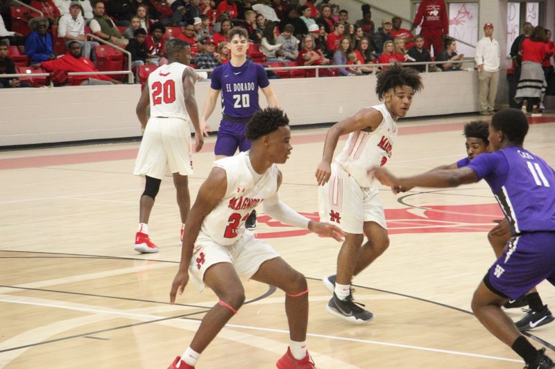 Derrian Ford (20), Colby Garland (22), and Adrien Walker, all sophomores at Magnolia, scored a combined 61 points in the team's dominating opening win Friday against El Dorado.  