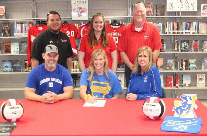 Magnolia senior Carlin Whaley (center, seated) signed to play volleyball with SAU next fall. She is pictured with her parents (seated) Leon and Shelly Whaley, along with coaches Dustin Bakenhus, Merina Powell and athletic director Dyun Long.