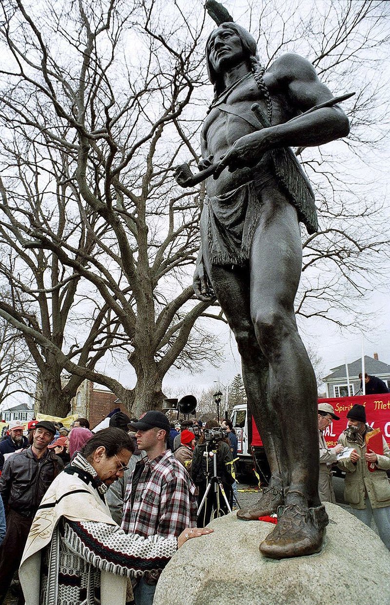 Andres Araica of Boston prays in front of a statue of the Wampanoag leader Massasoit in Plymouth, Mass., before a 1998 protest march on the American Indians’ annual National Day of Mourning. 