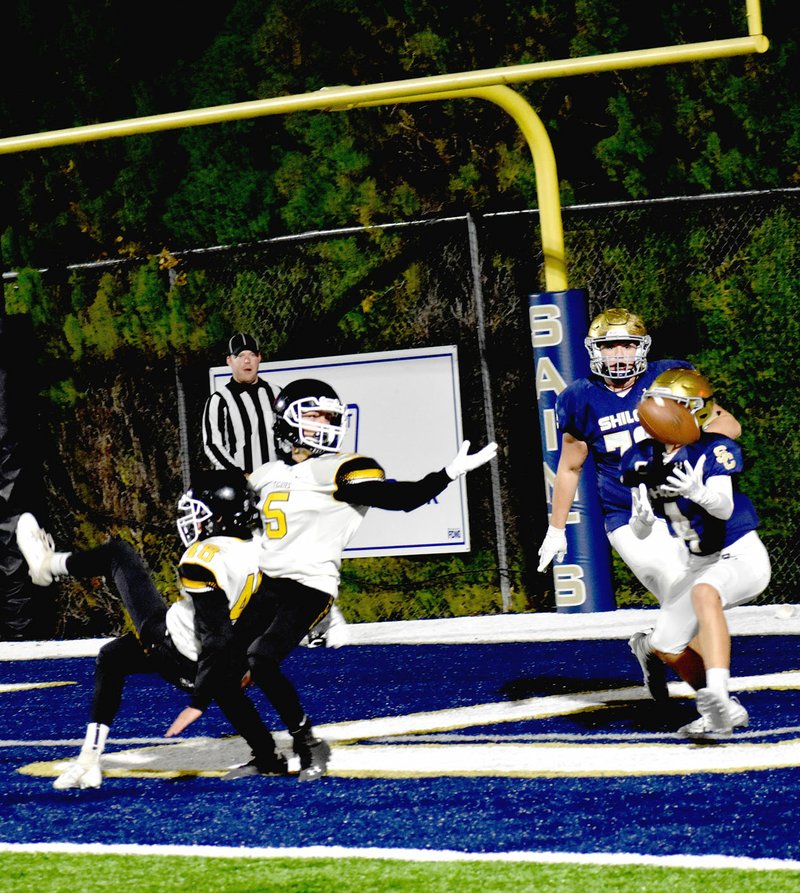 MARK HUMPHREY ENTERPRISE-LEADER Prairie Grove defensive backs Camden Patterson (left) and Tate Benoit fall off-balance after leaping to tip a pass that wound up caught in the end zone. That was the story of the game as the junior Saints defeated the junior Tigers, 32-8, on Thursday, Nov. 7 to win the 4A-1 junior high football conference championship.