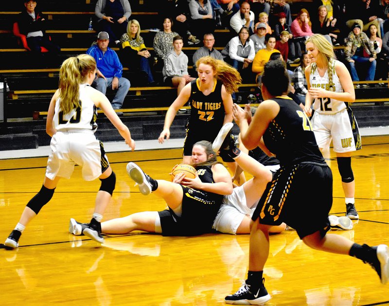 MARK HUMPHREY ENTERPRISE-LEADER Players from both teams converge as Prairie Grove sophomore Zoe Hobbs battles a West Fork player for control of the basketball. West Fork broke away from a 35-35 tie at the end of the third quarter to hand Prairie Grove a 52-42 loss on Thursday, Nov. 14, during the Duel at the Dome girls basketball tournament.