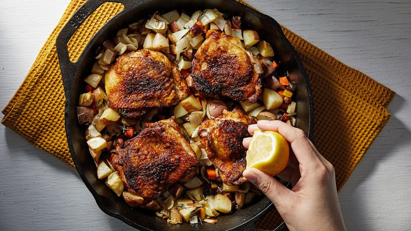 For The Washington Post/TOM MCCORKLE Skillet-Roasted Chicken Thighs With Potato-Carrot Hash