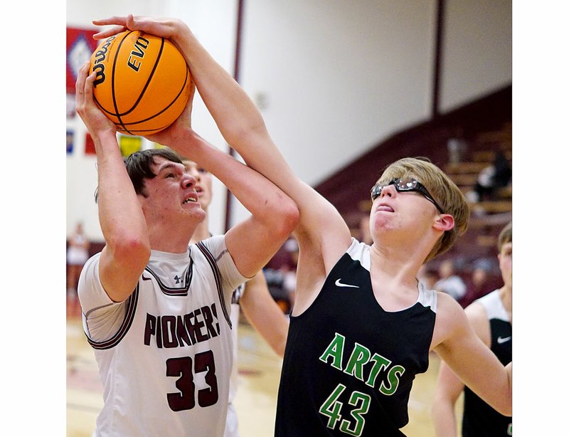 Westside Eagle Observer/RANDY MOLL Gentry's Garrison Jackson attempts a shot under the basket but his shot is blocked by Luke Seay of Arkansas Arts Academy on Nov. 19 at Gentry High School.