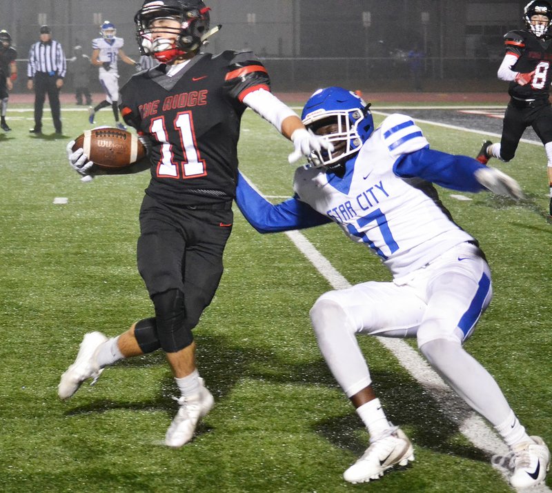 TIMES photographs by Annette Beard Senior Hunter Rains (No. 11) gathered in a Busey pass at the 5 to gain a first down, then twisted his way down to the 2 in the Friday, Nov. 22, second round of 4A-1 state playoffs game against the Star City Bulldogs in Blackhawk Stadium.