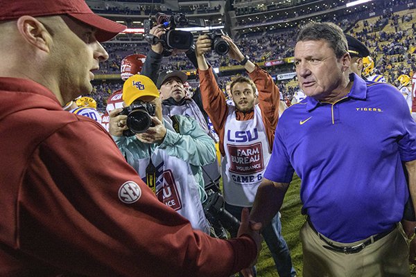 LSU coach Ed Orgeron, right, greets Arkansas coach Barry Lunney Jr. after LSU's 56-20 victory in a game in Baton Rouge, La., Saturday, Nov. 23, 2019. (AP Photo/Matthew Hinton)



